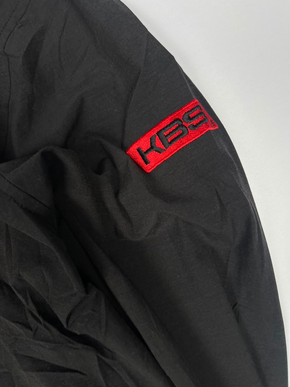 Black Full-Zip Bomber Jacket with Red Sleeve Logo and Chest Pocket