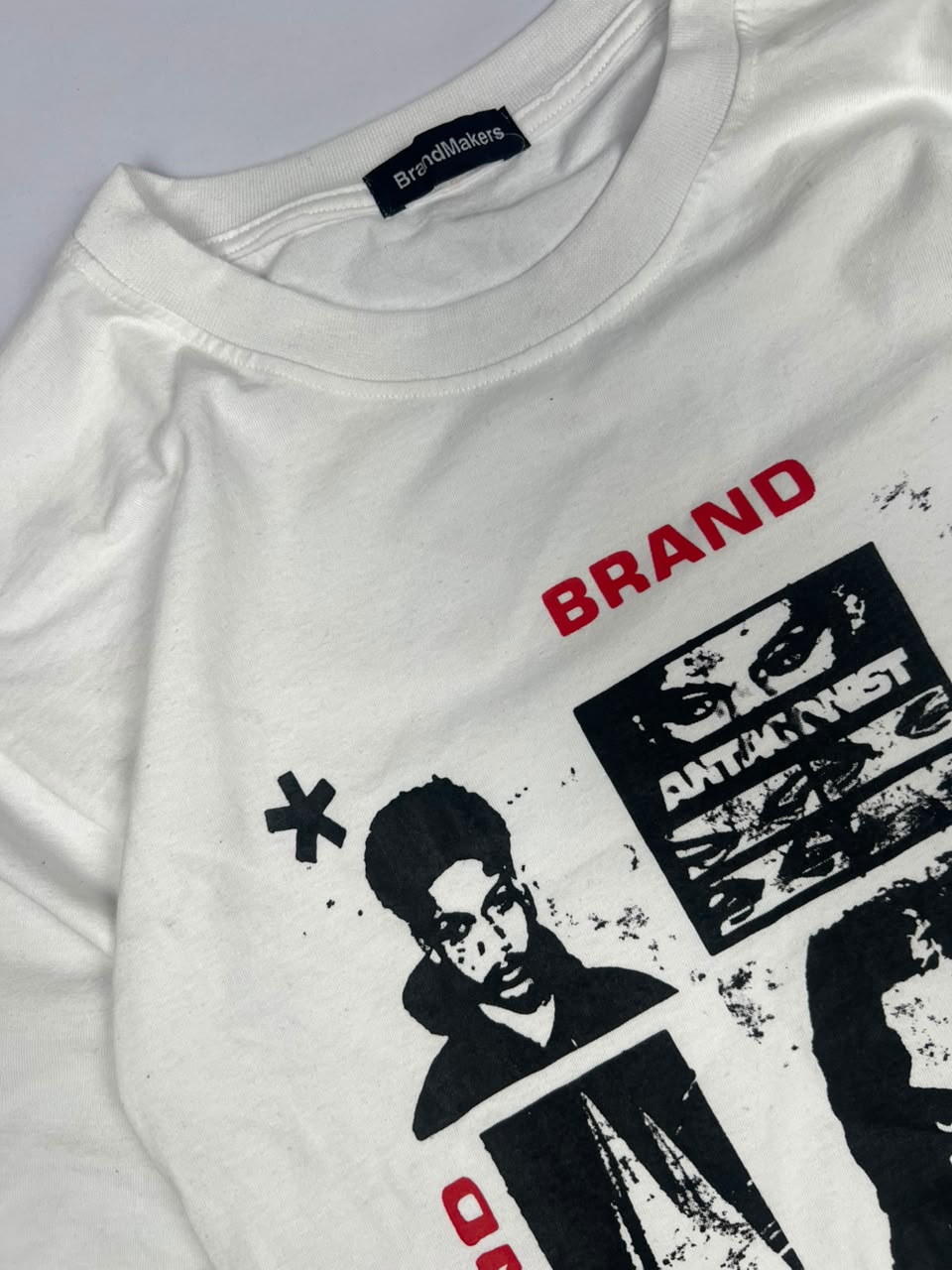 Graphic T-Shirt with Black Portrait Prints and Red Brand Text – Streetwear Style
