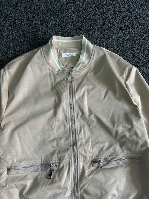 Oversized Beige Bomber with Striped Shirt Hem