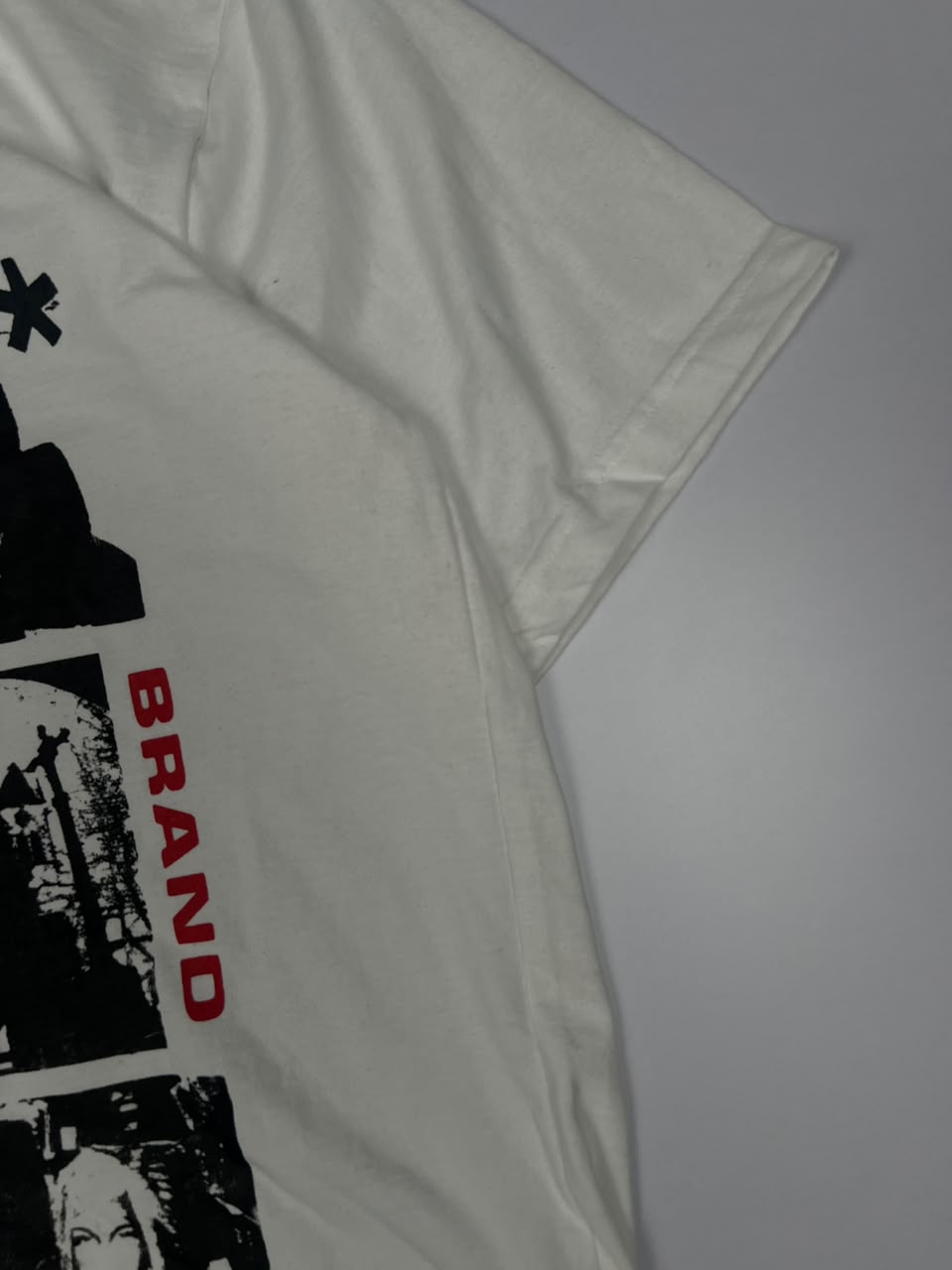 Graphic T-Shirt with Black Portrait Prints and Red Brand Text – Streetwear Style